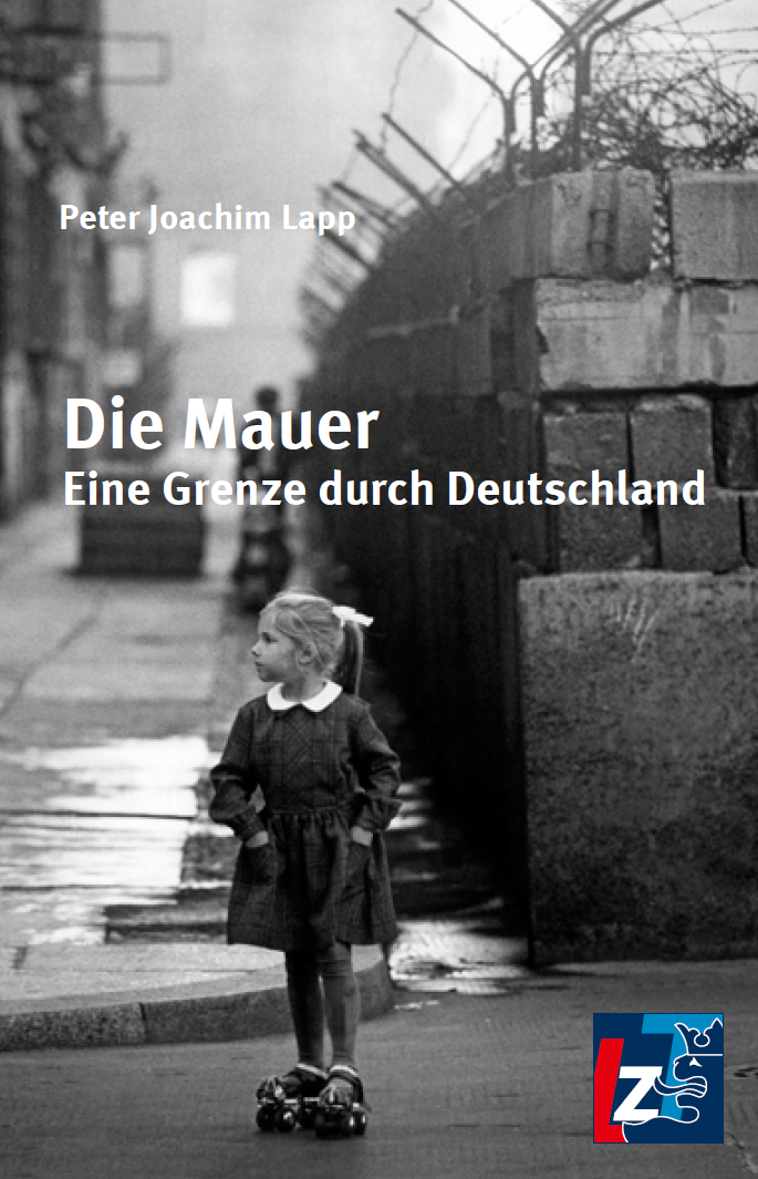 Schwarz-Weiß-Foto eines jungen Mädchens auf Rollschuhen in der Nähe der Berliner Mauer. Der Buchtitel lautet "Die Mauer: Eine Grenze durch Deutschland" von Peter Joachim Lapp. Im Hintergrund sind eine Stacheldrahtmauer und ein Wachturm zu sehen.